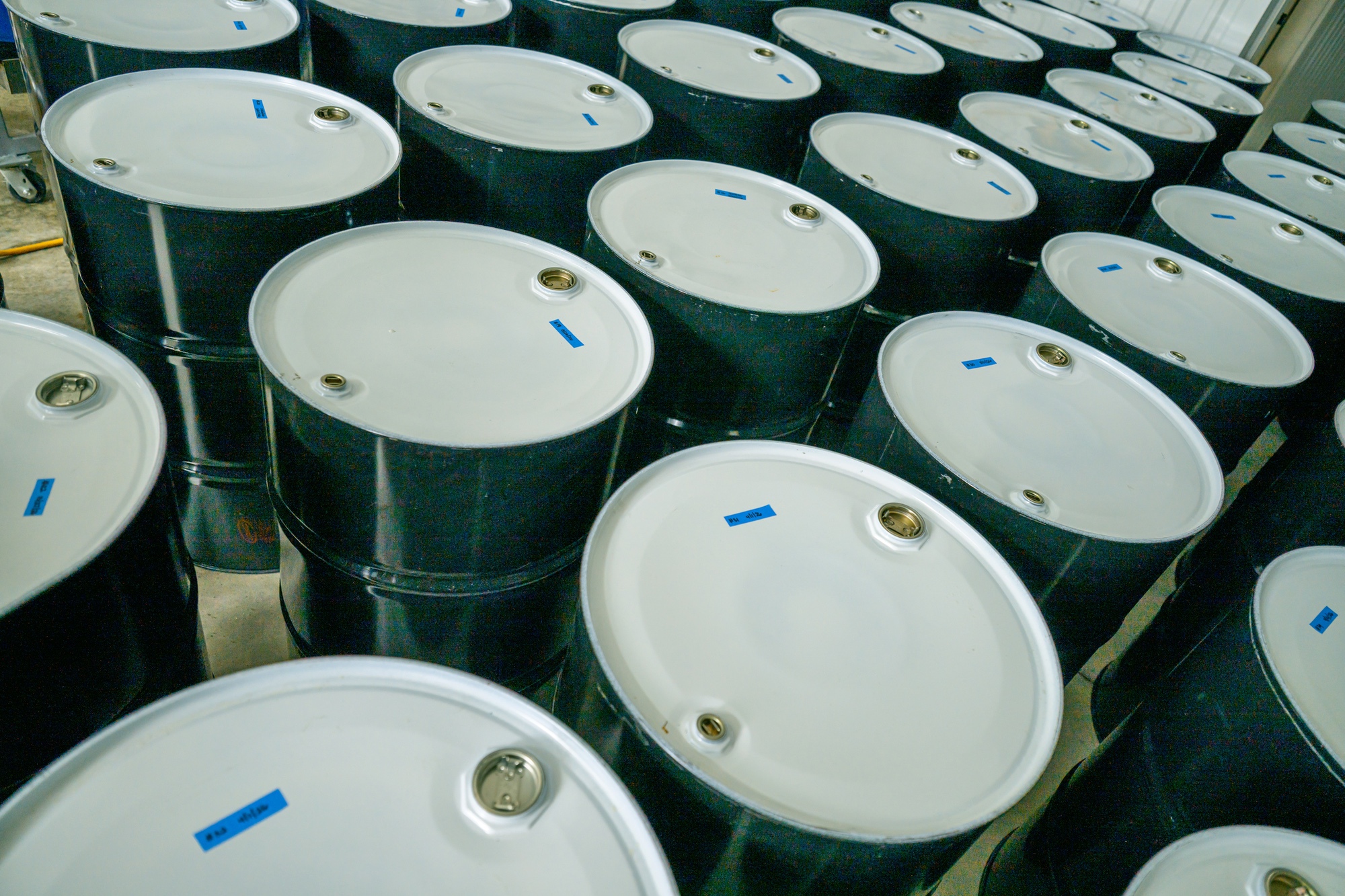 Rows of steel barrels of pure Vermont maple syrup ready for wholesale